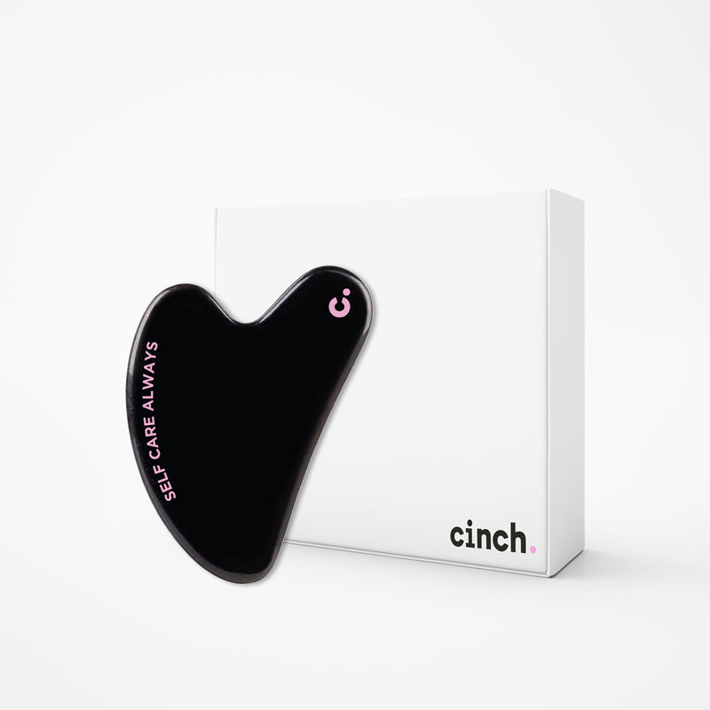 cinch skin black gua sha and white box with white background