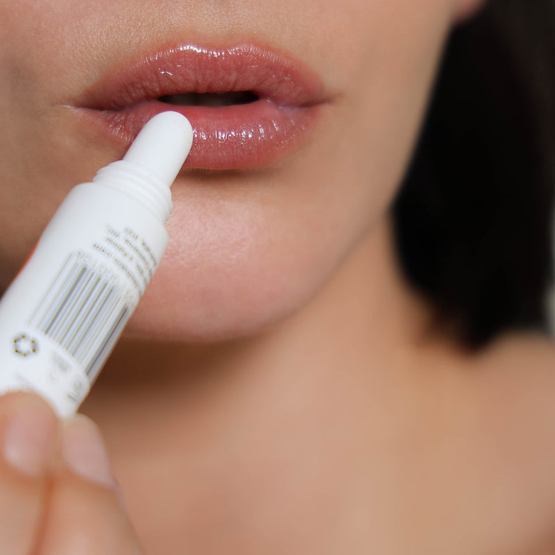 woman applying cinch minty glow lip balm