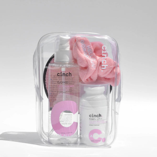 Cinch Skin Clear PVC Bag on white background. Bag is filled with Cinch skincare products