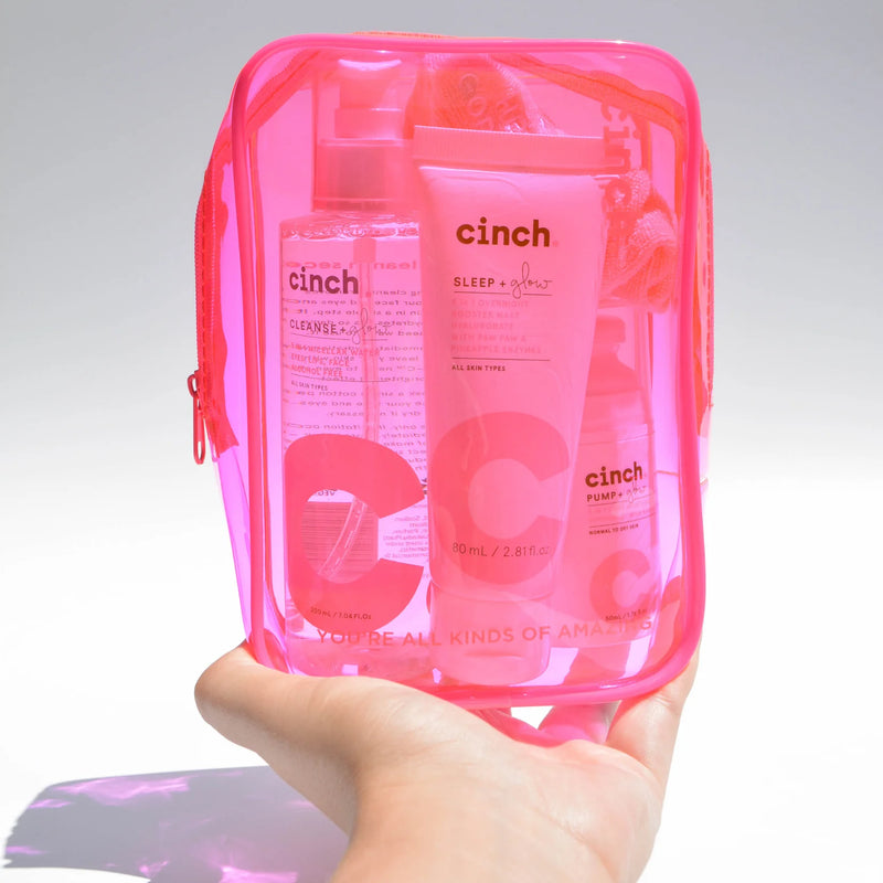 Cinch Skin Neon Pink PVC bag on white background being held by a hand